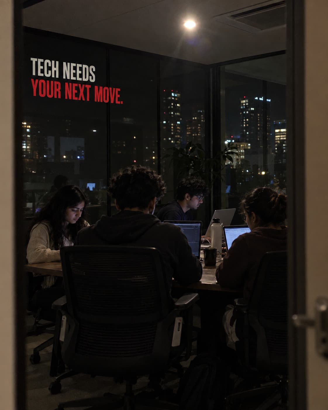 A development team working at night beneath the words: Tech needs your next move.